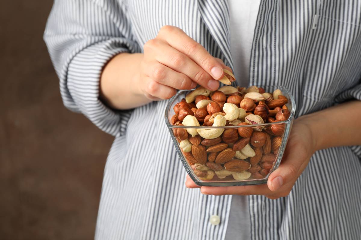 woman-hold-bowl-with-different-nuts-healthy-eatin-2023-11-27-05-25-21-utc (1)