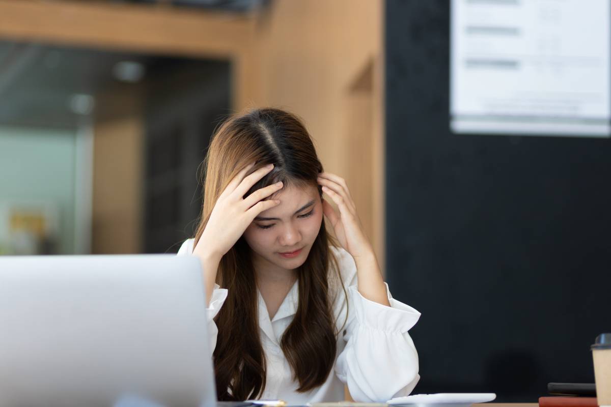 serious-businesswoman-working-on-documents-on-lapt-2023-11-27-05-10-27-utc (1)