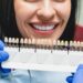 Whitening concept. Dental care, implants,veneers. Woman with perfect smile choosing teeth tooth tone