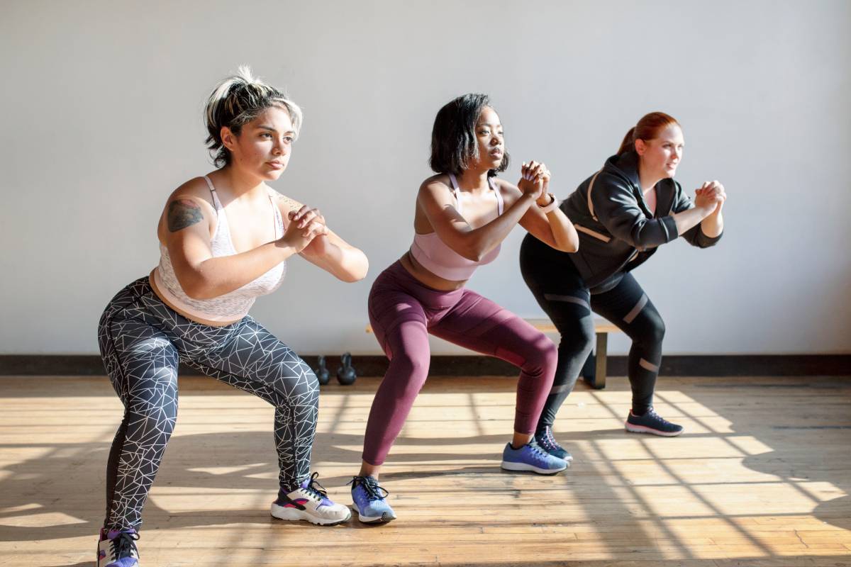 Women doing squats in fitness class