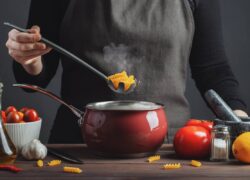 Cooking italian pasta in a pot in the kitchen, Chef preparing food, meal.
