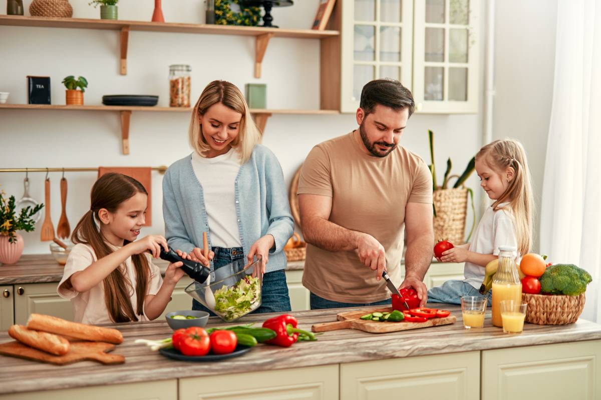 Happy Family Bonding and Preparing Healthy Meal Together in Bright Modern Kitchen