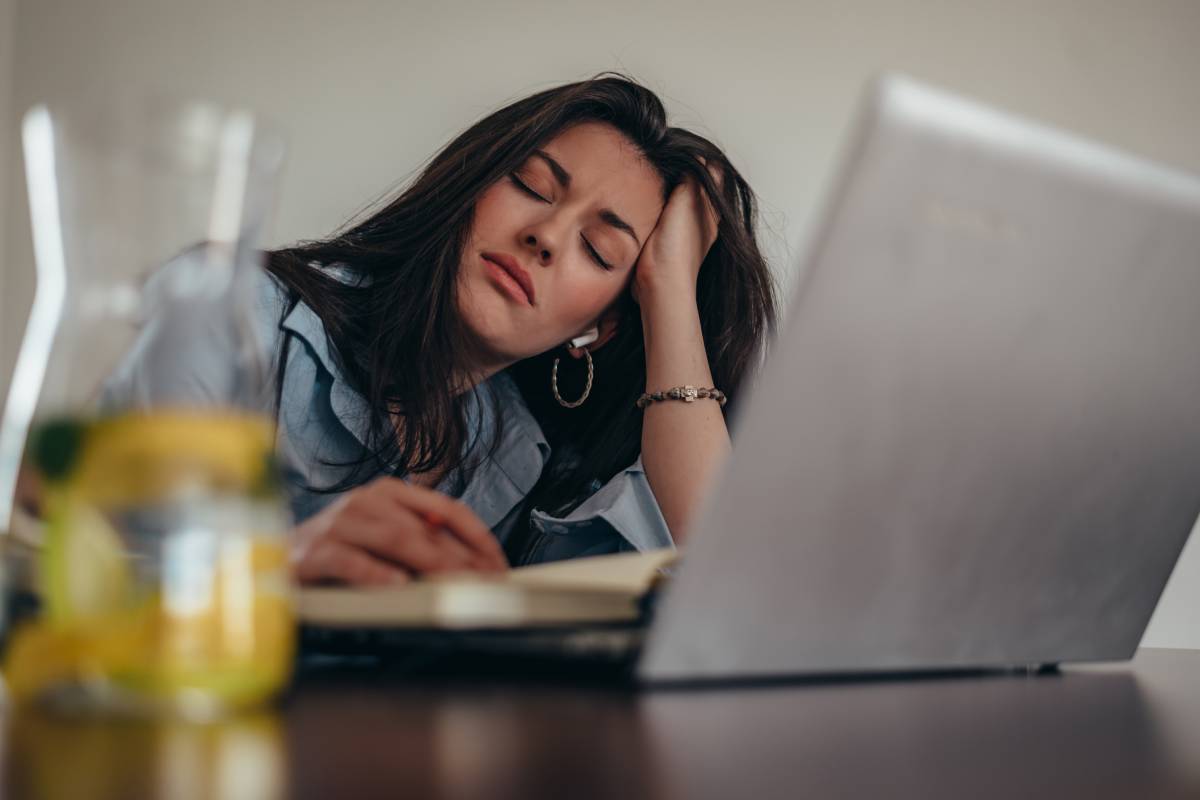 Tired businesswoman having a headache while in her office working on a laptop